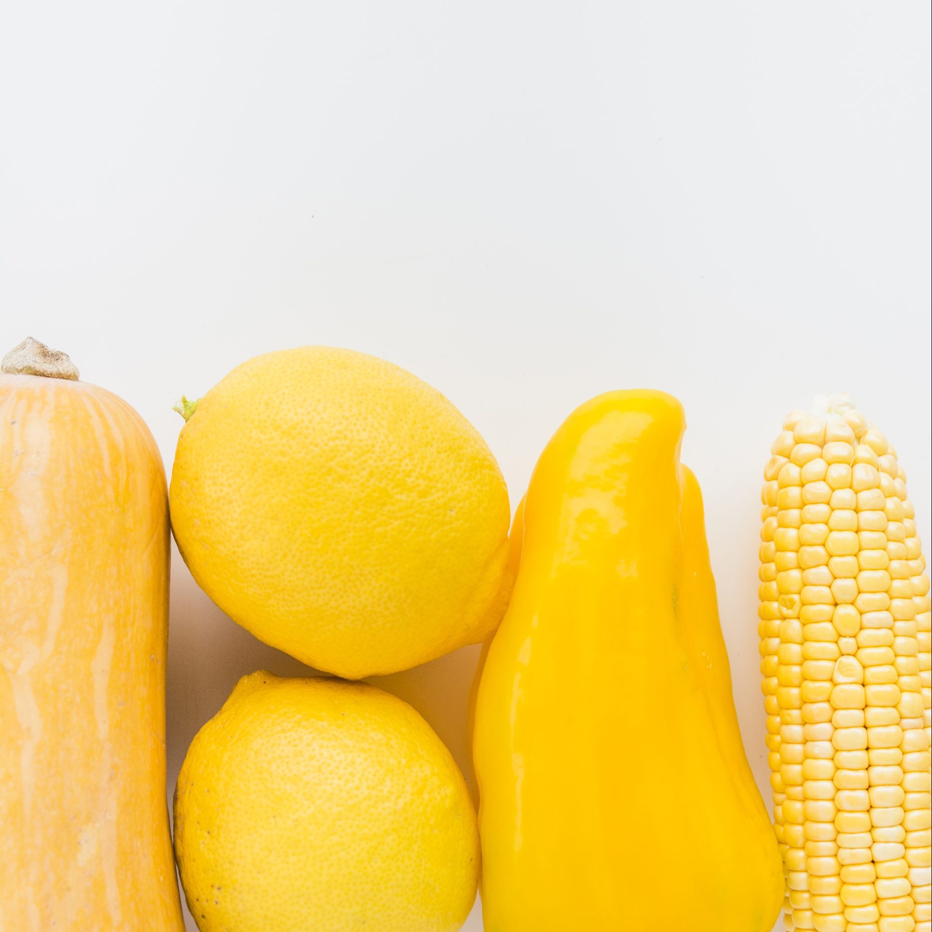 yellow, close up fresh yellow vegetables white background scaled