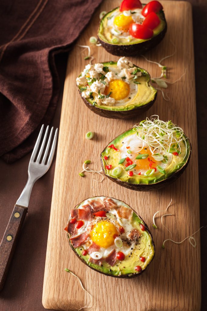 full of creaminess and healthy fats, avocados are a wonderful addition to your healthy lifestyle and can be eaten often, eggs baked avocado with bacon cheese tomato sprouts